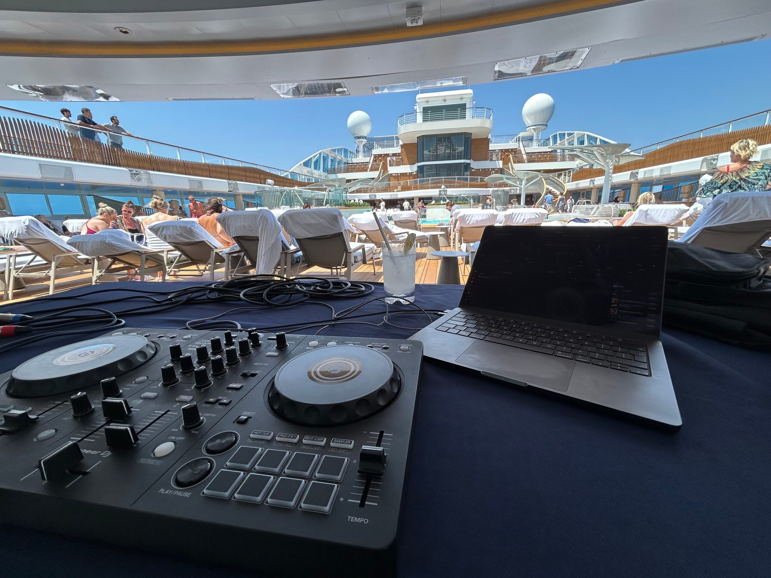 DJ Steve B playing a poolside set on the Oceania Allura cruise launch